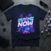 BUY ME NOW text overlaying a vibrant neon city skyline graphic in blue and pink, on a navy t-shirt