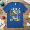 Bye Kindergarten Hello 1st Grade text with colorful letters and school icons on a blue t-shirt