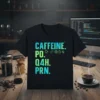Black t-shirt with "Caffeine PO Q4H PRN" text and icons for coffee, pills, gear, clock, and heartbeat line