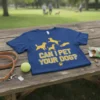 Blue t-shirt with yellow text "CAN I PET YOUR DOG?" and golden retriever graphics, dog accessories nearby