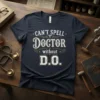 Navy t-shirt with white and gold text: "CAN'T SPELL DOCTOR without D.O." featuring caduceus symbols