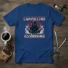 Cappuccino Assassino text with a ninja graphic holding swords on a blue t-shirt