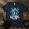 Capybara playing a blue electric guitar with lightning in the background and "Capybara Rock" text, on a navy t-shirt
