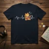 Cat playing guitar graphic with musical notes and heartbeat line on a navy blue t-shirt