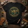 Certified Snake Handler t-shirt design with a green cobra coiled around gold text