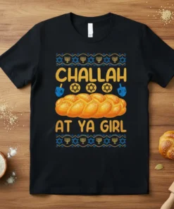 Black t-shirt with "Challah At Ya Girl" text, a braided challah loaf graphic, dreidels, and Star of David symbols for