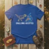 Challenge Accepted t-shirt with a T-Rex and a cyclist on a penny-farthing bike
