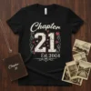 Black t-shirt with "Chapter 21 Est. 2004" in distressed white and pink font, surrounded by small hearts and decorative swirls