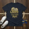 Cheer LEADER t-shirt design with gold glitter text, pom poms, and megaphone graphic on navy blue shirt