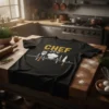 Black t-shirt with "CHEF ECG" text and culinary graphics like a chef hat, spatula, and knife forming a heartbeat line