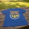 Chicks Dig Me T-Shirt featuring three cartoon chicks, one wearing sunglasses and digging, with bold yellow and red text