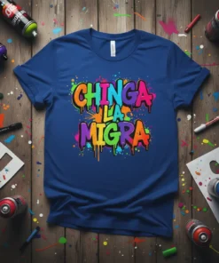 Chinga La Migra text in colorful graffiti style on a blue t-shirt, with spray paint splatters
