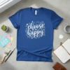 Blue t-shirt with white and yellow "choose happy" script text surrounded by floral and sun graphics