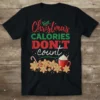 Christmas Calories Don't Count text with gingerbread cookies, candy canes, and hot cocoa graphic on a black t-shirt