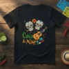Cinco de Mayo t-shirt with two sugar skulls, an acoustic guitar, and festive elements