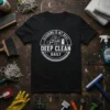 T-shirt with white text "Cleaning Is My Beat Deep Clean Daily" inside a circular emblem, featuring cleaning tools graphic