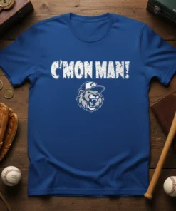 C'MON MAN! text with a roaring lion wearing a baseball cap graphic on a royal blue t-shirt