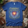 Compassion Has No Borders quote with hands holding a glowing heart and floral border on a blue t-shirt