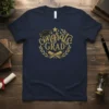 Navy blue t-shirt with gold "Congrats GRAD" text, graduation cap, stars, and laurel wreath graphic