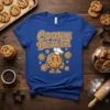 Cookie Dealer t-shirt design with a cartoon cookie character in a chef hat holding cookies