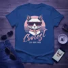 Coolest Cat Mom Ever t-shirt featuring a white cat wearing sunglasses and a pink collar with retro sunset design