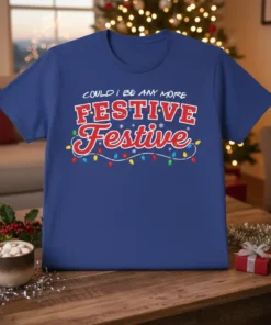 Blue t-shirt with red and white text that reads "COULD I BE ANY MORE FESTIVE Festive" and colorful Christmas lights