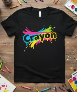 Black t-shirt with the word "Crayon" in bold yellow letters, surrounded by colorful paint splatters in pink, blue, and green