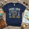 Navy blue t-shirt with white and yellow text: "CRUISE CREW MOST LIKELY TO GET LOST LOST On The Ship", featuring