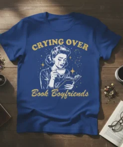 Crying Over Book Boyfriends T-Shirt featuring a vintage woman reading and drinking tea, with stars and constellations, in yellow text