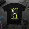Black t-shirt with "CUK PAR DARE ON BUKERS JUAK AISTE CUMERS" text, a dabbing skeleton graphic, and circuit board design
