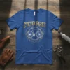 Blue t-shirt with "CYCYOLOGGIST" in gold text above a line art bicycle within a gear graphic