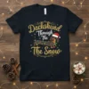 Dachshund Through The Snow Christmas T-Shirt featuring a dachshund wearing a Santa hat and wrapped in colorful lights