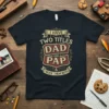 I HAVE TWO TITLES DAD AND PAP & I ROCK THEM BOTH text on a black t-shirt, vintage distressed design