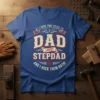 I Have Two Titles Dad and Stepdad And I Rock Them Both quote on a blue t-shirt, vintage distressed font