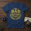 Dad of the Birthday Prince quote with crown and laurel wreath graphic on a navy blue t-shirt