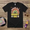 Dad of the Groovy One text with retro rainbow and stars on a black t-shirt