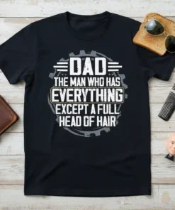 Dad The Man Who Has Everything Except A Full Head of Hair quote on a black t-shirt, with gear graphics