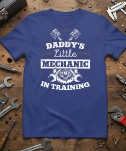 Daddy's Little Mechanic In Training text with piston and wrench graphics on a blue t-shirt