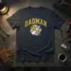 Dadman T-Shirt featuring the text "DADMAN" in distressed yellow font with a wrench and baby bottle graphic