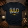 Black t-shirt with white and gold text "After further review... DALLAS STILL SUCKS" and a bull skull with crossed baseball