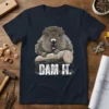 Dam It. phrase with a cartoon beaver holding a log, printed on a navy blue t-shirt