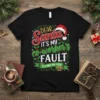 Black t-shirt with "Dear Santa It's My Co-Worker's Fault" Christmas text design, featuring Santa hat and holly graphics