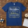 December IS MY Birthday YES, THE WHOLE MONTH text in white and gold on a blue t-shirt, with decorative borders