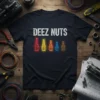 Black t-shirt with "DEEZ NUTS" text in white and colorful neon-style tool graphics below