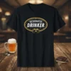 Black t-shirt with "DESIGNATED DRINKER" text in white and gold, featuring two beer mugs graphic