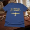 Blue t-shirt with gold text "Do I Look Like I Fly Economy?" and a gold airplane graphic