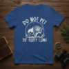 Graphic t-shirt featuring a bison illustration with the text "DO NOT PET THF FLUFFY COWS" in a circular design
