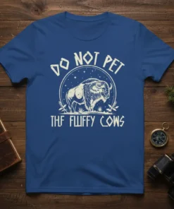Graphic t-shirt featuring a bison illustration with the text "DO NOT PET THF FLUFFY COWS" in a circular design