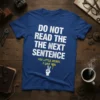 Blue t-shirt with white text "DO NOT READ THE NEXT SENTENCE" and yellow text "YOU LITTLE REBEL. I LIKE YOU."