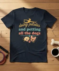 Doing Pilates and Petting All the Dogs t-shirt with a pilates silhouette, dogs, and paw prints